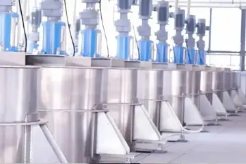 Industrial 5-ton stainless steel tanks storing ground pigment paste at StarColor factory